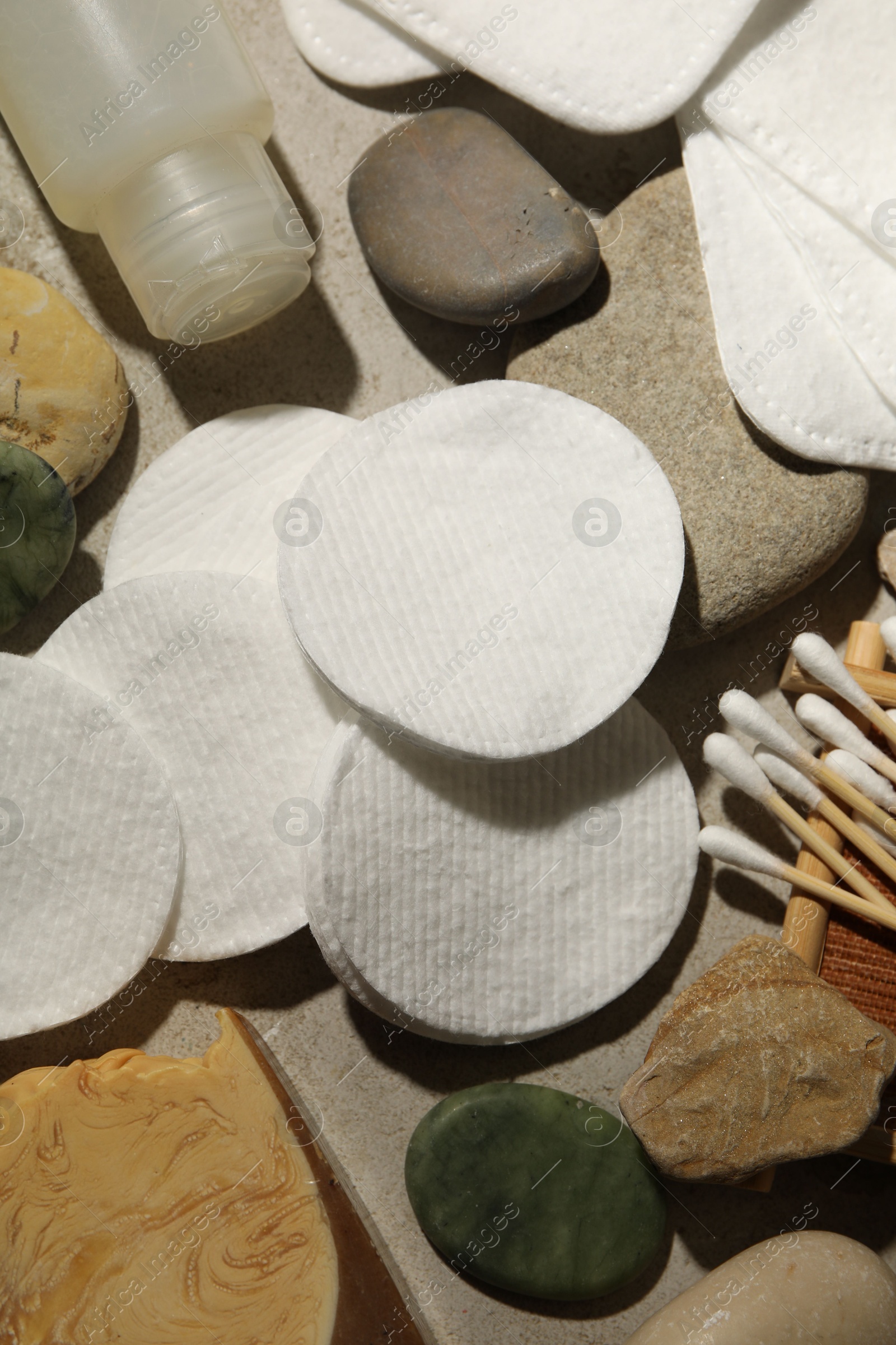 Photo of Flat lay composition with cotton pads and swabs on grey textured table