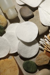 Photo of Flat lay composition with cotton pads and swabs on grey textured table