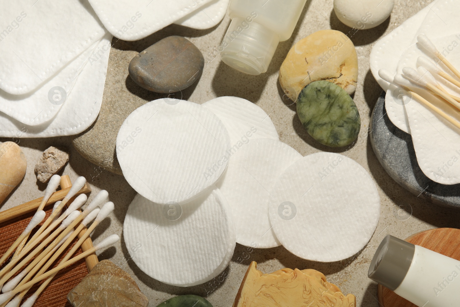 Photo of Flat lay composition with cotton pads and swabs on grey textured table