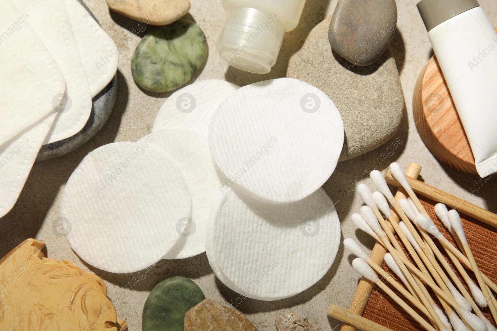 Photo of Flat lay composition with cotton pads and swabs on grey textured table