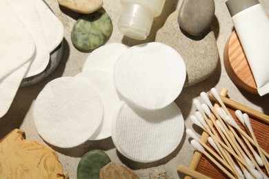 Photo of Flat lay composition with cotton pads and swabs on grey textured table