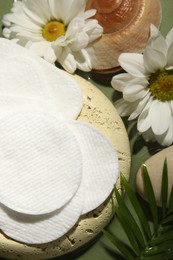 Photo of Flat lay composition with cotton pads on green table