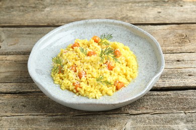 Photo of Delicious pumpkin risotto on wooden table, closeup