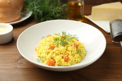 Photo of Delicious pumpkin risotto on wooden table, closeup