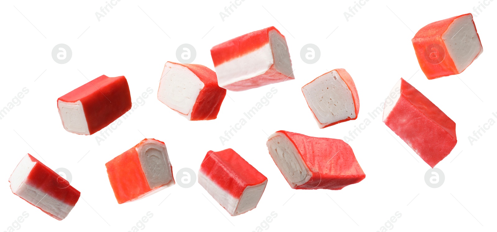 Image of Crab stick pieces in air on white background