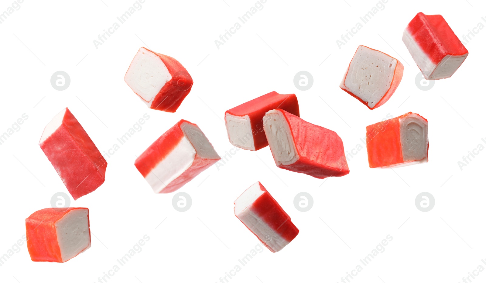 Image of Crab stick pieces in air on white background