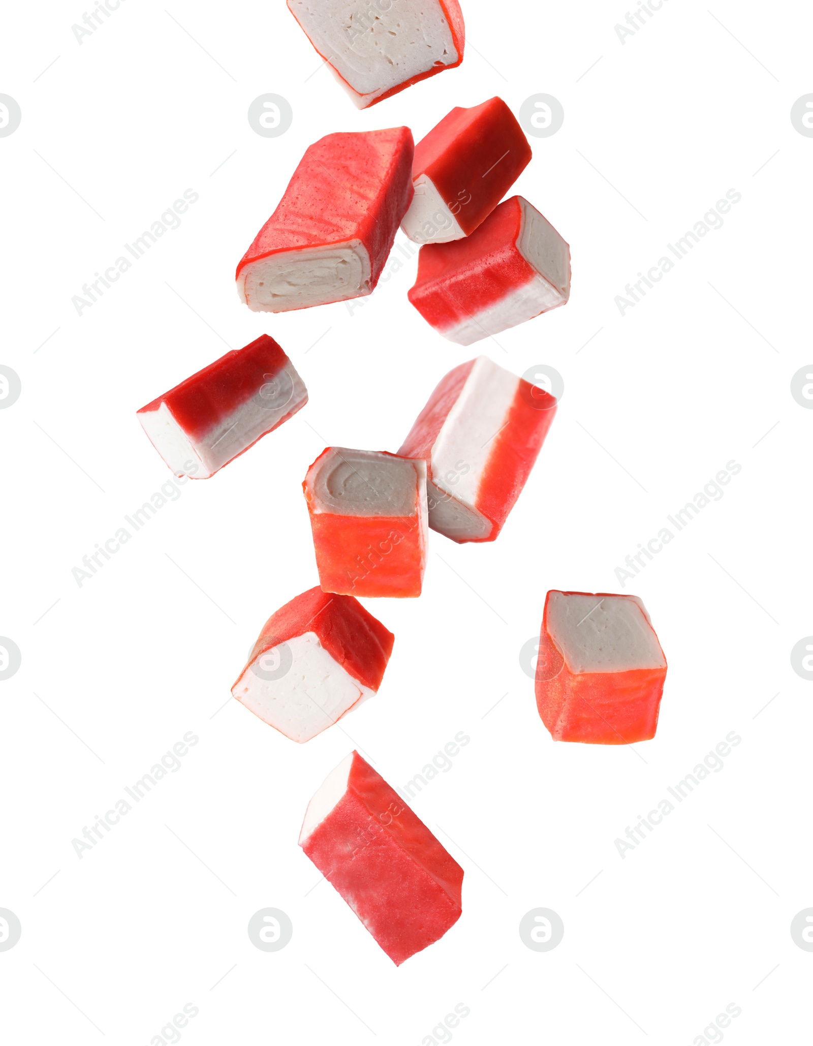 Image of Crab stick pieces falling on white background