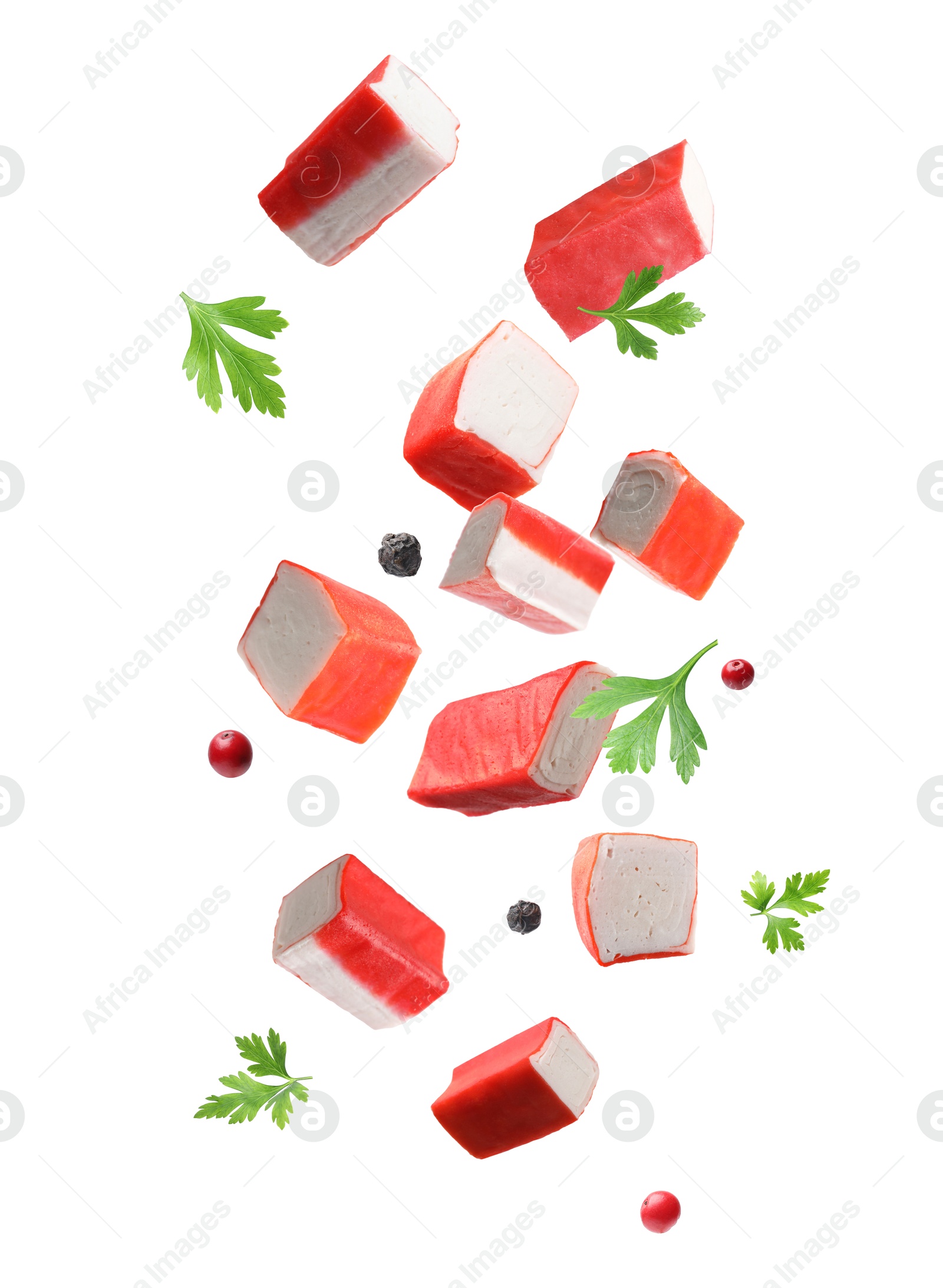 Image of Crab stick pieces, parsley and mix of peppers in air on white background