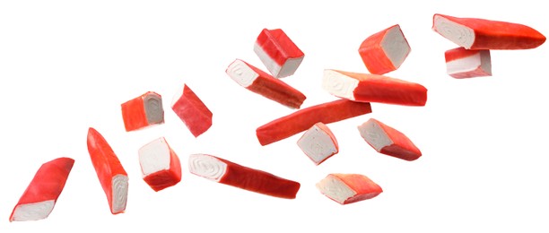 Image of Crab stick pieces in air on white background