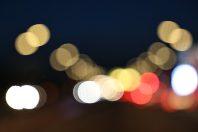 Photo of Blurred view of city street with lights at night