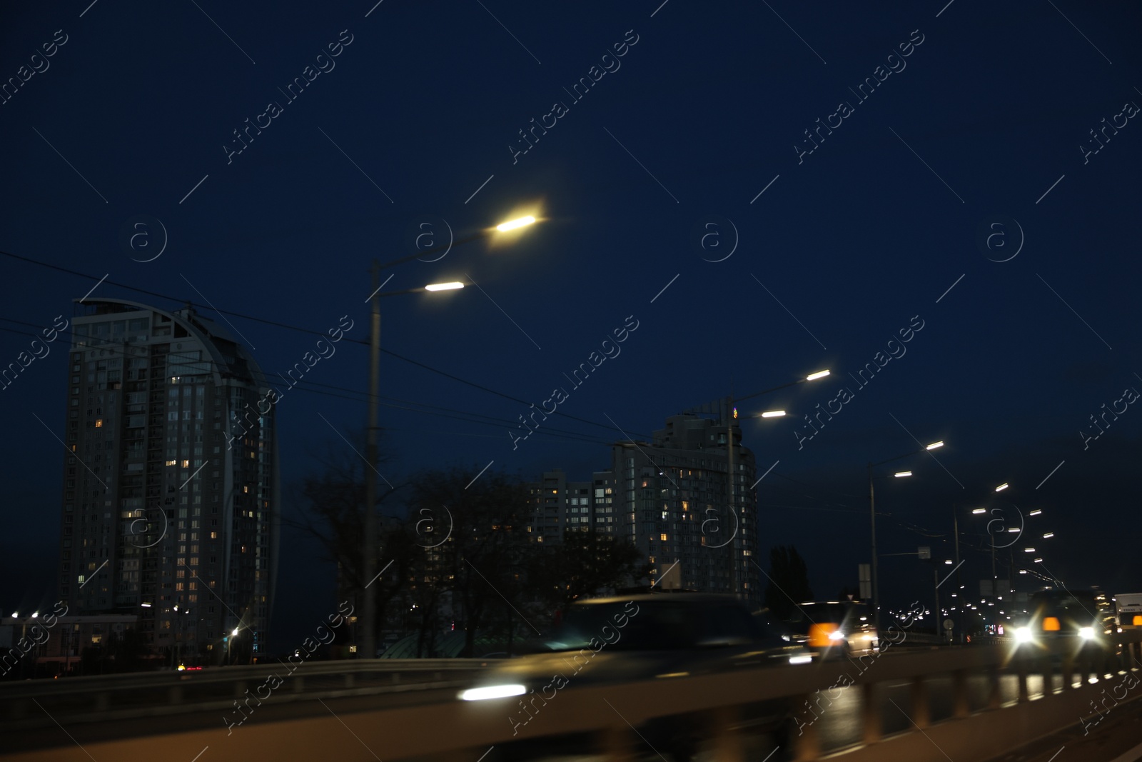 Photo of Cityscape with road traffic and street lights in evening