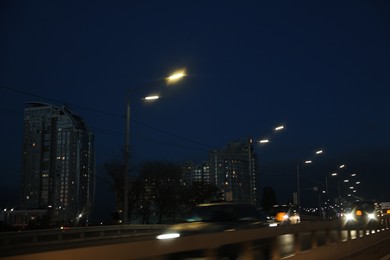 Photo of Cityscape with road traffic and street lights in evening