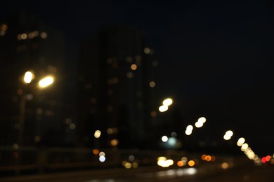 Photo of Blurred view of cityscape with road traffic and street lights at night