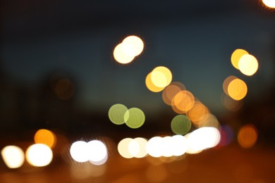 Photo of Blurred view of city street with lights at night