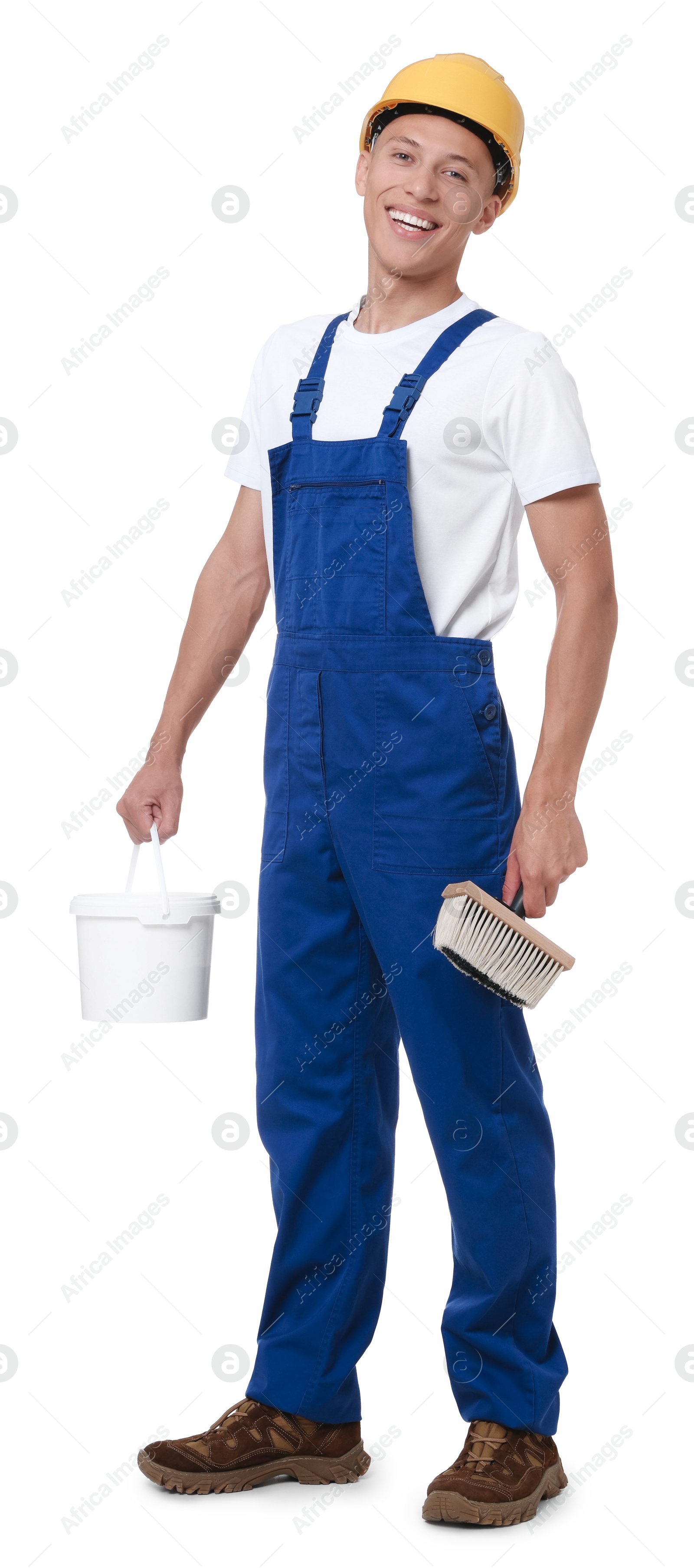 Photo of Young decorator with paint brush and bucket on white background