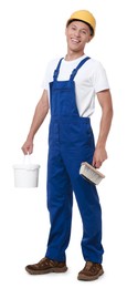 Young decorator with paint brush and bucket on white background