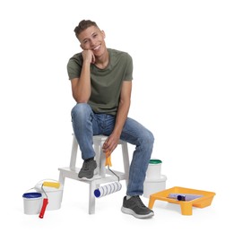 Young decorator with different tools on white background