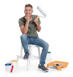 Young decorator with different tools on white background