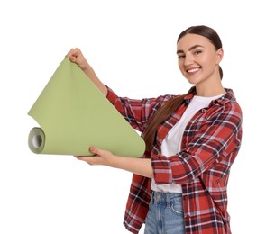 Young decorator with roll of wallpaper on white background