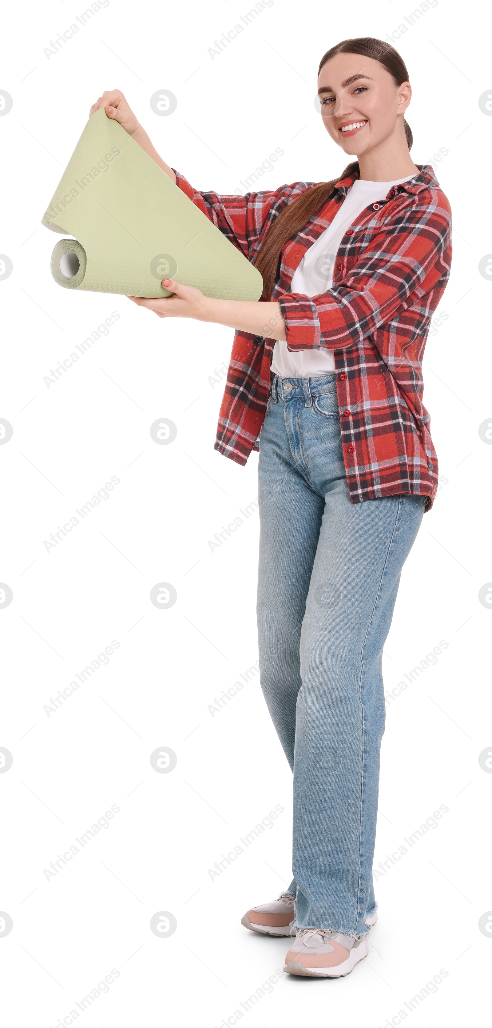 Photo of Young decorator with roll of wallpaper on white background