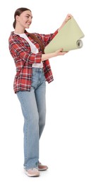 Photo of Young decorator with roll of wallpaper on white background