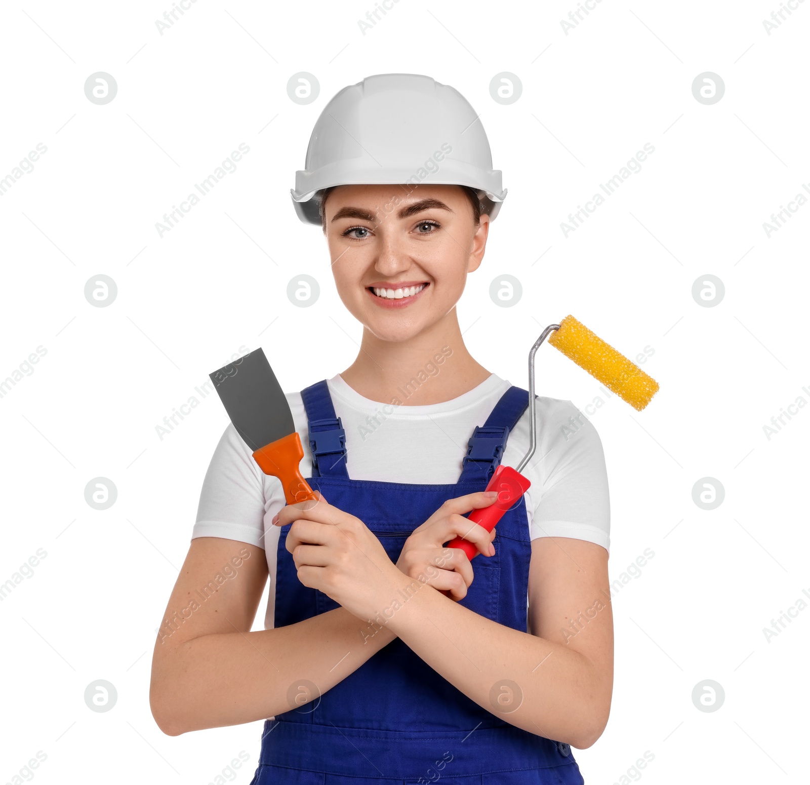 Photo of Portrait of young decorator with paint roller and putty knife on white background