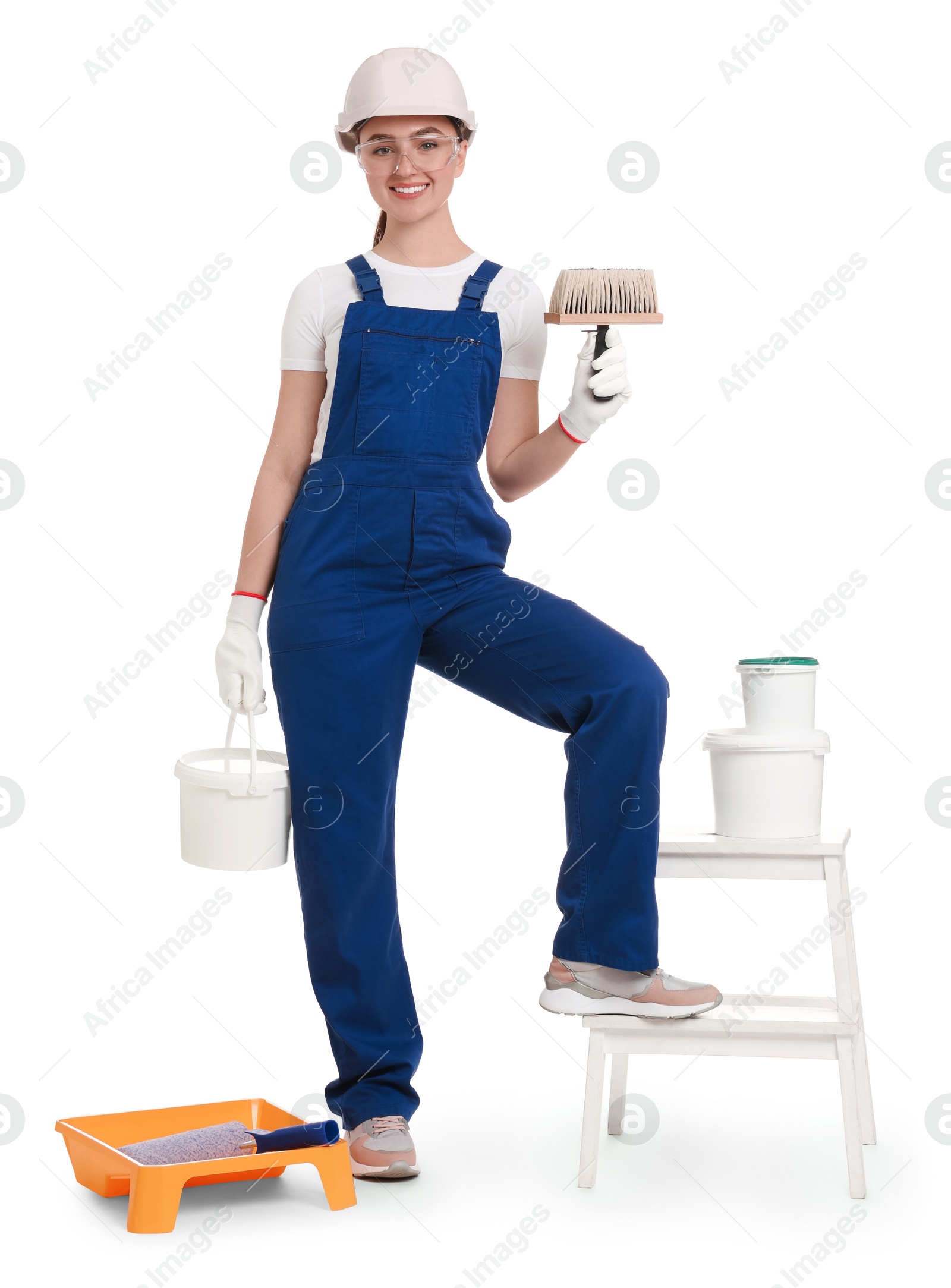 Photo of Young decorator with different tools on white background