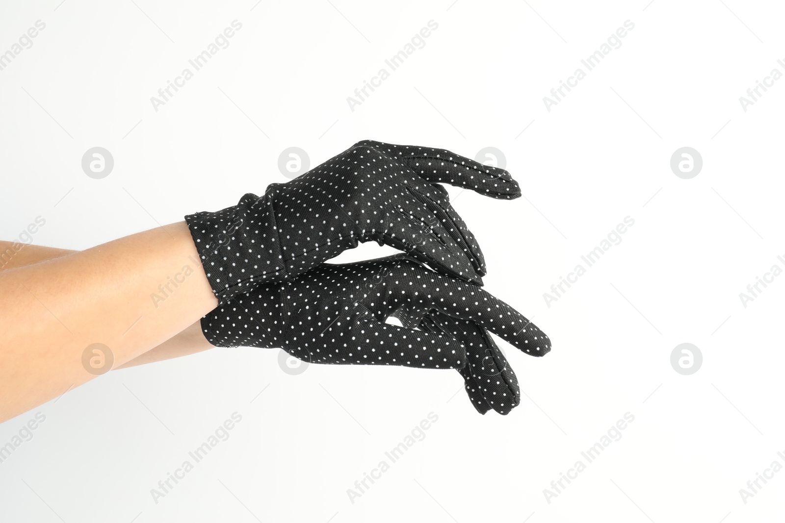 Photo of Woman in elegant polka dot gloves on white background, closeup