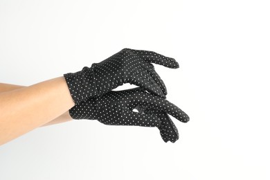 Woman in elegant polka dot gloves on white background, closeup