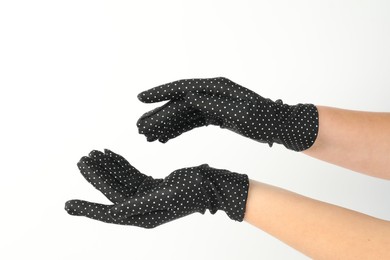 Woman in elegant polka dot gloves on white background, closeup