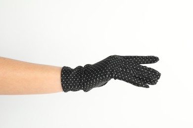 Woman in elegant polka dot glove on white background, closeup