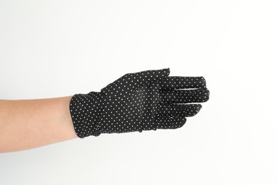 Woman in elegant polka dot glove on white background, closeup