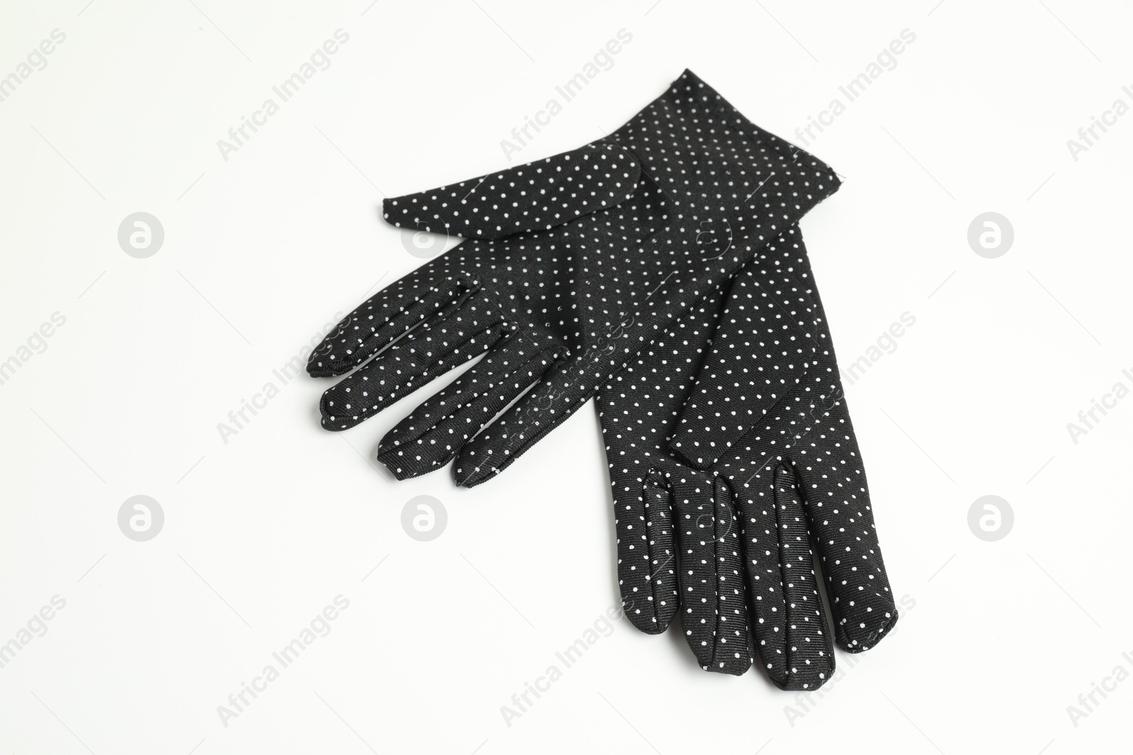 Photo of Elegant polka dot gloves on white background