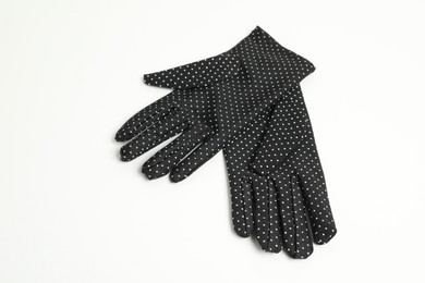 Elegant polka dot gloves on white background