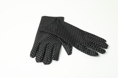 Photo of Elegant polka dot gloves on white background