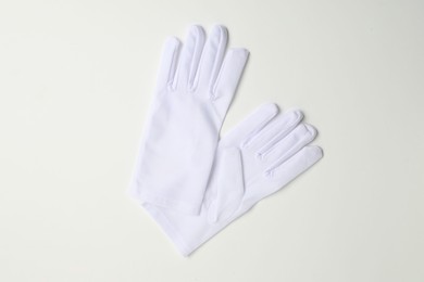 Elegant gloves on white background, top view