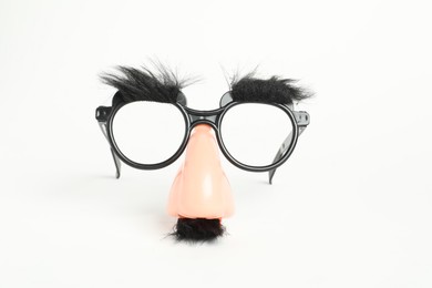 Funny mask with fake mustache, nose and glasses on white background