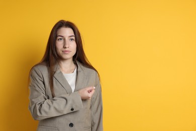 Photo of Woman making promise on orange background, space for text. Oath gesture