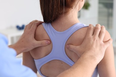 Photo of Osteopath working with patient in clinic, closeup. Manual therapy