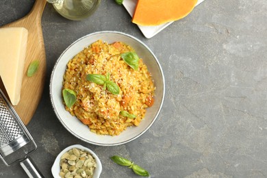 Photo of Delicious pumpkin risotto on grey table, flat lay. Space for text