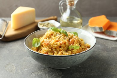 Photo of Delicious pumpkin risotto on grey table, closeup