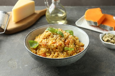 Photo of Delicious pumpkin risotto on grey table, closeup