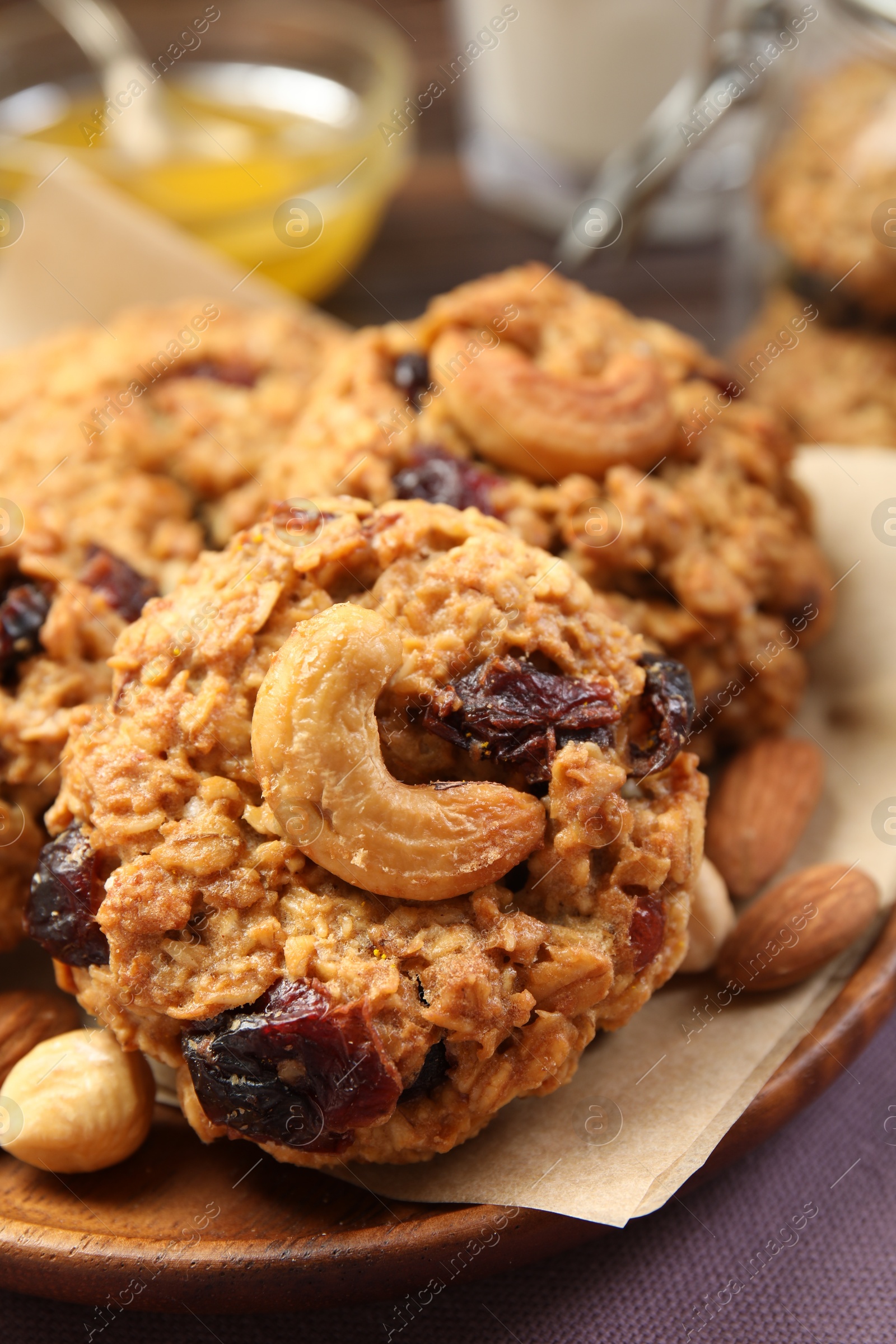 Photo of Delicious oatmeal cookies with raisins and nuts on table, closeup