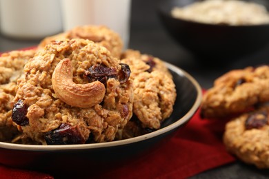 Photo of Delicious oatmeal cookies with raisins and nuts on table, closeup