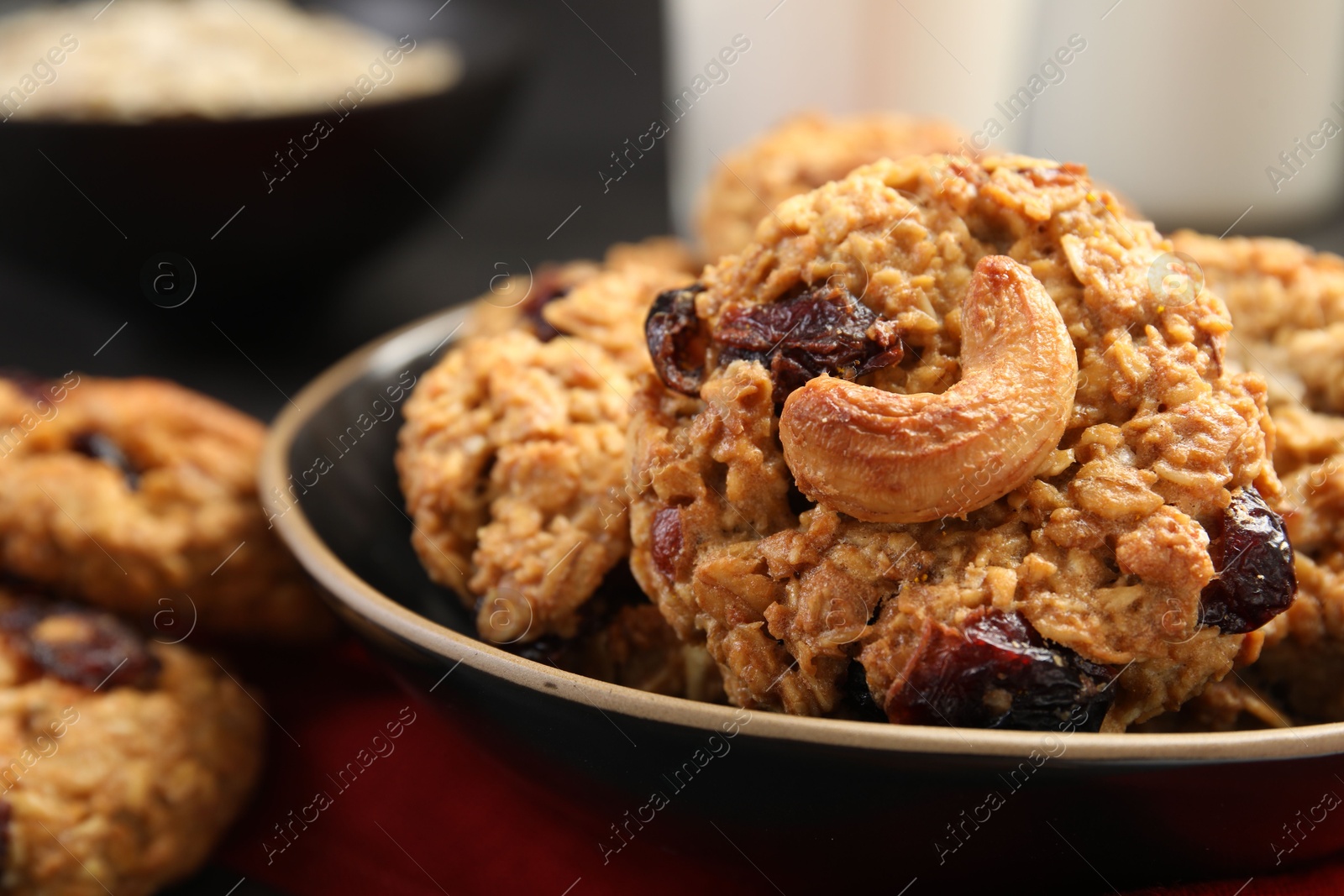 Photo of Delicious oatmeal cookies with raisins and nuts on table, closeup