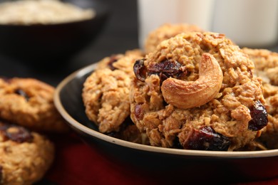 Photo of Delicious oatmeal cookies with raisins and nuts on table, closeup