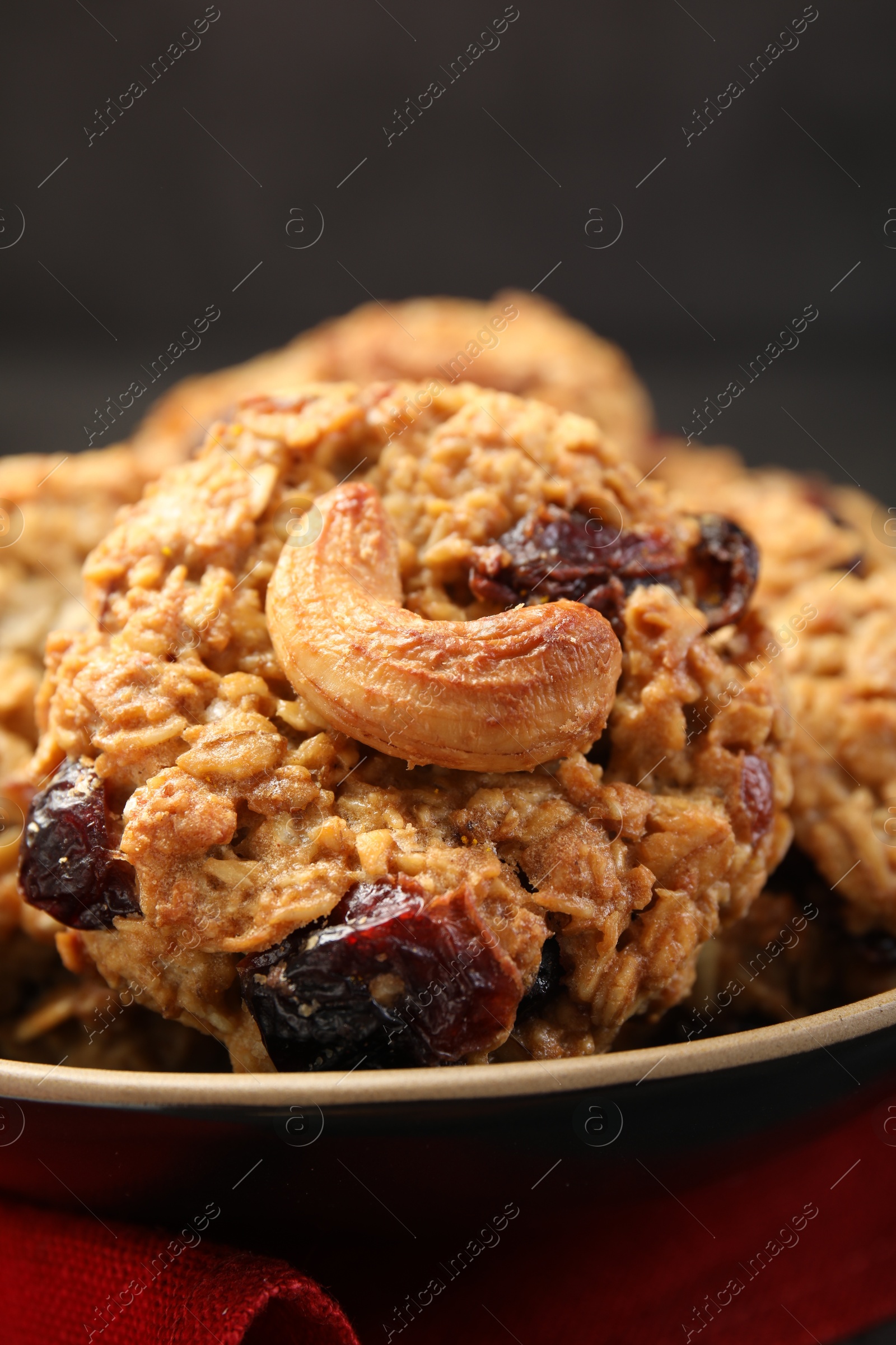 Photo of Delicious oatmeal cookies with raisins and nuts on table, closeup