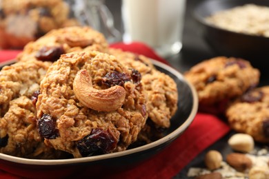 Photo of Delicious oatmeal cookies with raisins and nuts on table, closeup