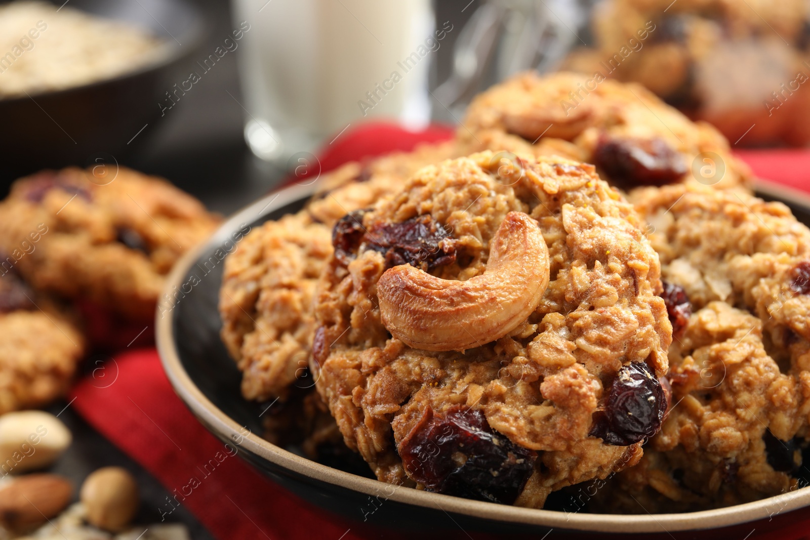 Photo of Delicious oatmeal cookies with raisins and nuts on table, closeup