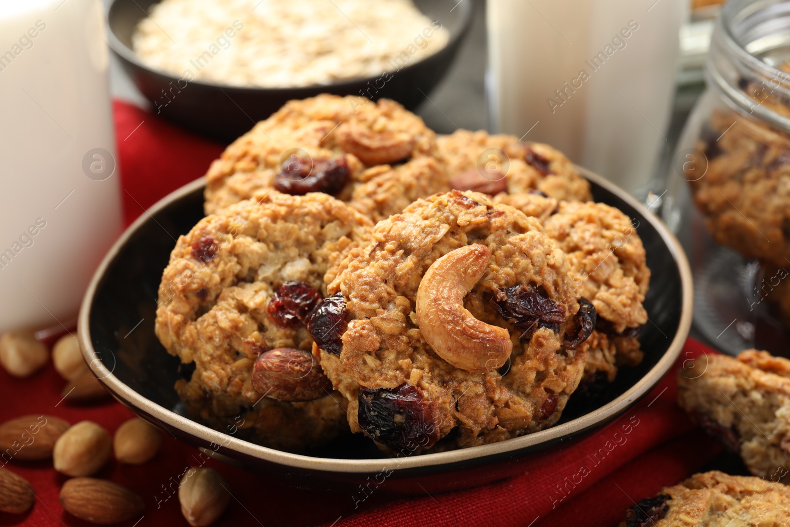 Photo of Delicious oatmeal cookies with raisins and nuts on table, closeup